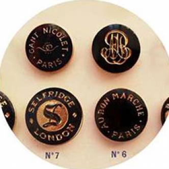 Four engraved press-studs for "Au bon marché Paris", "Gants Nicolet Paris", "Selfridge London"